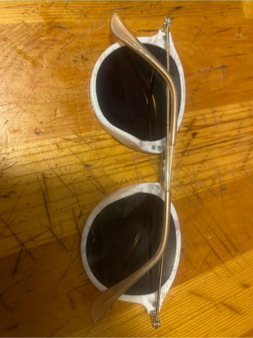 Round White Marble Sunglasses with Dark Lenses